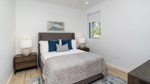 right and Airy Modern Bedroom with Gray Upholstered Bed and Seascape Painting