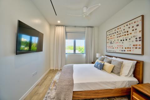 Modern minimalist bedroom with wooden bed and wall art