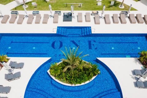 The image shows an aerial view of a luxury swimming pool area