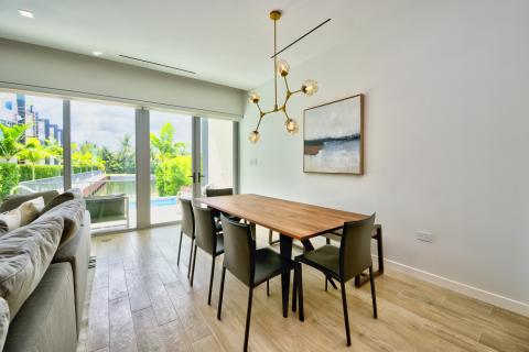 Modern dining room with wooden table and sliding glass doors