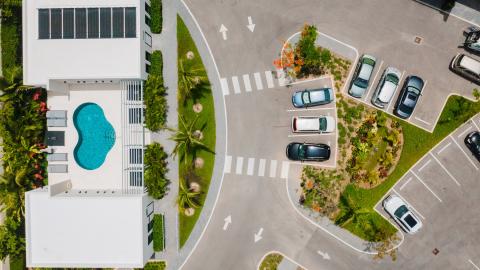 Aerial View of Modern Building Complex with Pool and Tropical Landscaping