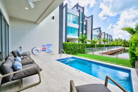 Modern outdoor living space with pool and lounge furniture