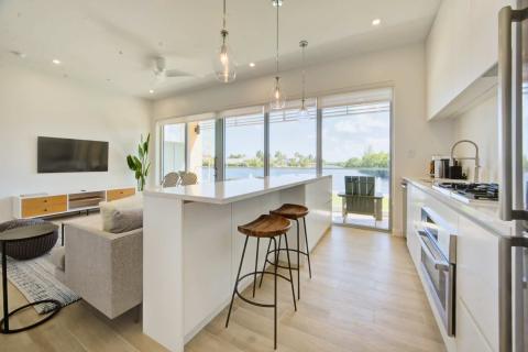 Well-lit kitchen and living area with water view