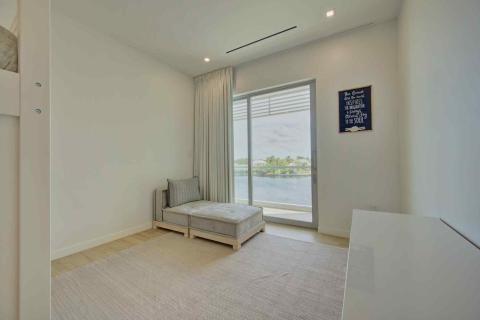 One Canal Point: Minimalist room with daybed, large window view of water, and inspirational decor