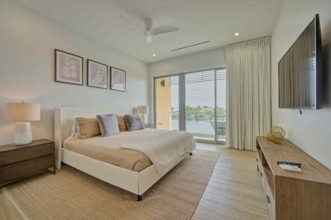 One Canal Point: Contemporary bedroom with double bed, balcony view, and neutral tones
