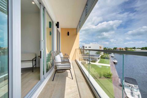 One Canal Point: Balcony with cushioned chairs and picturesque waterfront view