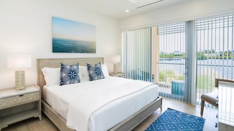 Modern Coastal Bedroom with Serene Water View and Stylish Deco