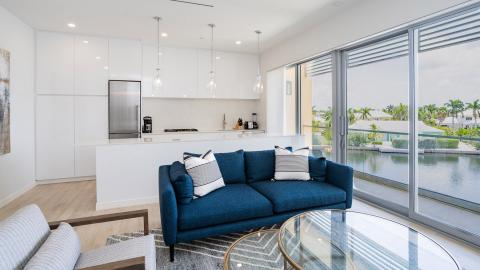 Modern Living Room with Waterfront View and Sleek Kitchen Area