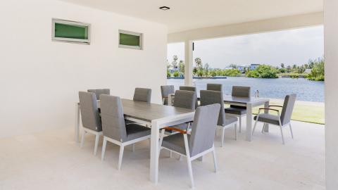 Modern Outdoor Dining Area with Serene Waterfront View