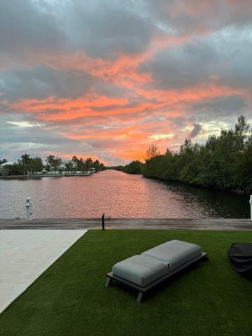 This image captures a breathtaking sunset with a vibrant display of orange and pink clouds in the sky