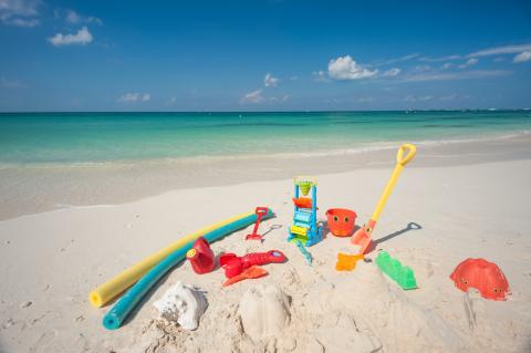 Colorful beach toys on sand  