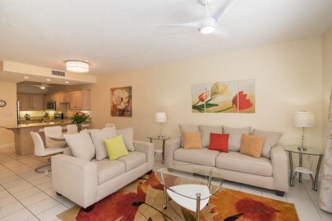   Living room with colorful cushions and open kitchen