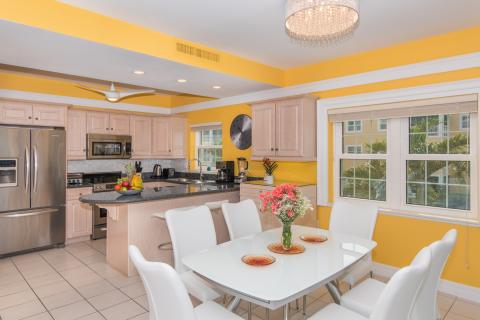   Bright kitchen with light wood cabinetry and dining area