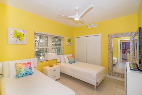   Cheerful bedroom with yellow walls and two single beds