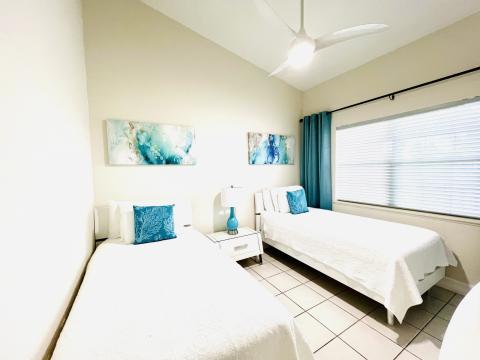 Blue accented tidy bedroom.