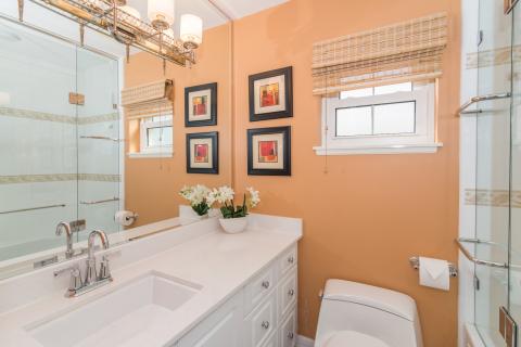 Stylish orange bathroom with fixtures