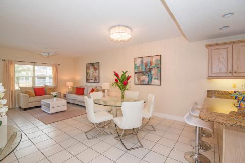   Modern living room and dining area with beige sofas