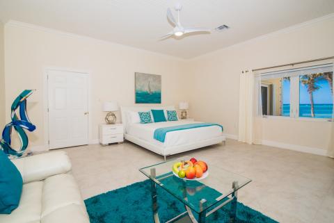   Spacious bedroom with beach view and blue accents