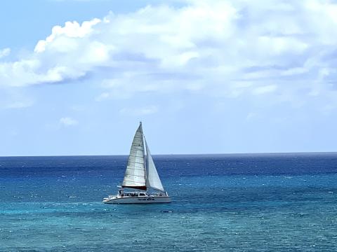 Sailboat on vibrant blue ocean