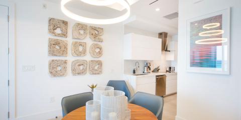 This image depicts a bright and modern kitchen and dining area with minimalist design