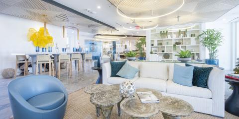 This image features a modern and stylish interior space that possibly serves as a lounge or a casual meeting area within an office or commercial facility
