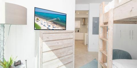 This image displays a modern, small living space that efficiently integrates multiple functions within a tight area