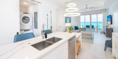 This image displays a modern beachfront apartment