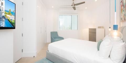 The image shows a modern and well-lit bedroom