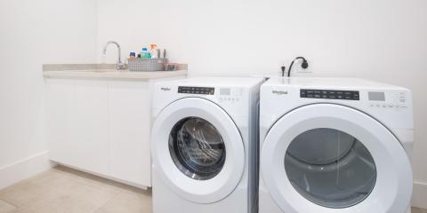 The image shows a modern laundry room equipped with two Whirlpool appliances: a washing machine and a dryer placed side by side