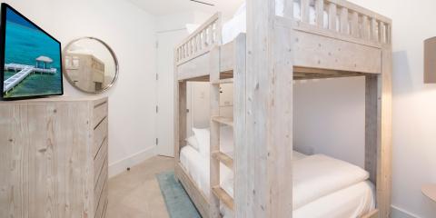 The image shows a modern, minimalist room furnished with a sturdy wooden bunk bed structure, featuring two tiers of beds