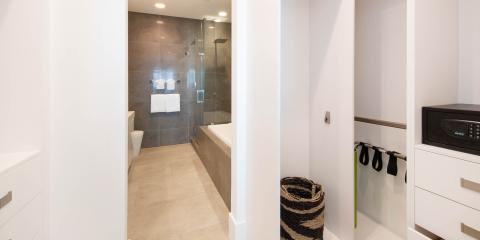 This image features a modern bathroom and a closet area
