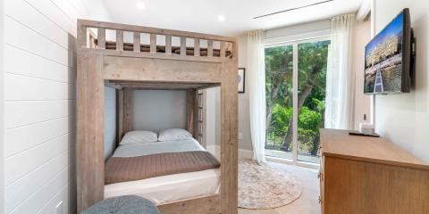 This image features a modern bedroom interior with a wooden bunk bed