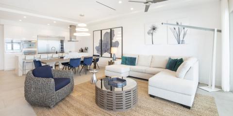 This image features a modern, open-plan living space that combines the living room, dining area, and kitchen