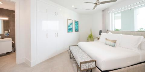 This image shows a modern and stylish bedroom connected to an en-suite bathroom