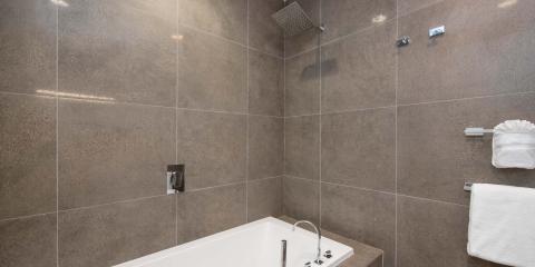 This image shows a modern bathroom with a square bathtub