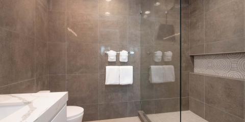This image shows a modern bathroom with a walk-in shower