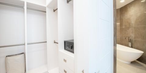 This image shows a modern interior space with a walk-in closet section to the left and a bathroom section to the right