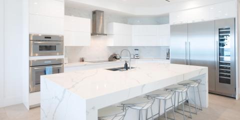 This image shows a modern, sleek kitchen featuring a predominantly white color palette