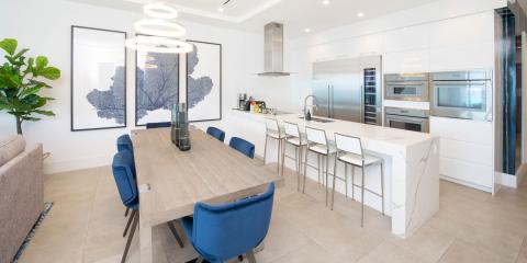 This image shows a modern, spacious kitchen and dining area with a contemporary design