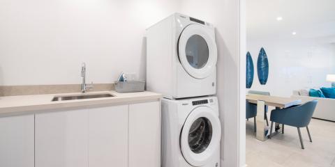 The image depicts a modern laundry space that seamlessly integrates into a living area