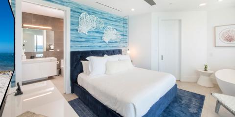 This image features a modern and stylish bedroom with a coastal theme