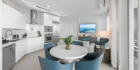 This image shows a modern, open-plan living space that combines a kitchen and living room