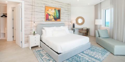 This image shows a well-decorated bedroom with modern and coastal design elements