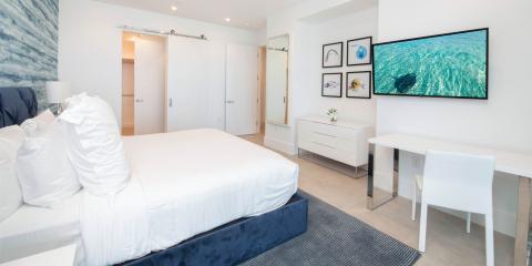 The image displays a modern and brightly lit bedroom