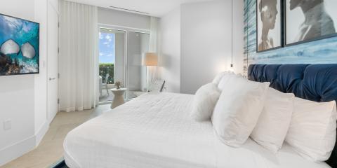 The image shows a modern and well-lit bedroom