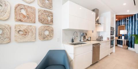 The image shows a modern and well-lit kitchen area with an adjacent sitting area