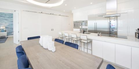 The image shows a modern, well-lit kitchen and dining area