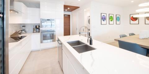 The image shows a modern, well-lit kitchen and dining area with contemporary design elements