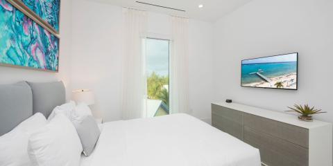 This image features a modern, well-lit bedroom setting