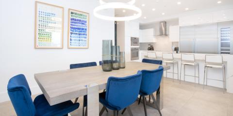 This image features a modern, well-lit kitchen and dining area